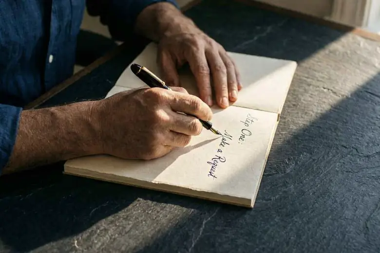 An open journal on a warm wooden surface representing the practice of writing clear Law of Attraction requests